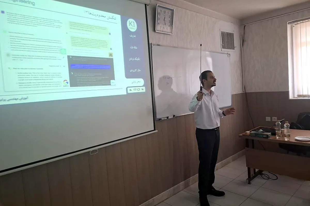 Keivan Jamali explaining a slide on the projector screen
